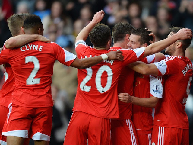 Morgan Schneiderlin of Southampton is congratulated by team mates as he scores their first goal during the Barclays Premier League match against Fulham on November 9, 2013