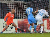 Marseille's French midfielder Florian Thauvin scores a goal past Napoli's Spanish goalkeeper Jose Manuel Reina and Colombian defender Pablo Armero during the UEFA Champions League group F football match SSC Napoli vs Olympique de Marseille at the San Paol
