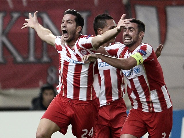 Olympiacos' Greek defender Kostas Manolas celebrates scoring a goal during the UEFA Champions League Group C football match Olympiacos vs Benfica on November 5, 2013