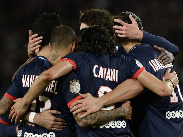 Paris Saint-Germain's players celebrate after scoring their second goal from the penalty spot during the French L1 football match between PSG and Nice on November 9, 2013