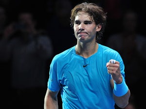 Tomic retirement puts Nadal through