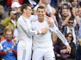 Real Madrid's Portuguese forward Cristiano Ronaldo celebrates with Real Madrid's Welsh striker Gareth Bale after scoring during the Spanish league football match Real Madrid vs Real Sociedad on November 9, 2013
