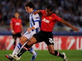 Ruben Pardo of Real Sociedad battles with Luis Antonio Valencia of Manchester United during the UEFA Champions League Group A match between Real Sociedad de Futbol and Manchester United at Estadio Anoeta on November 5, 2013