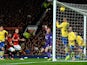Man United's Robin van Persie heads in the opening goal against Arsenal on November 10, 2013