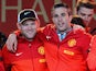Manchester United's Dutch striker Robin van Persie and English striker Wayne Rooney celebrate on stage after winning the Premier League title for the 13th time, during the team's victory parade outside the town hall in Manchester, north west England, on M