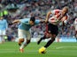 Man City's Sergio Aguero and Sunderland's Wes Brown battle for the ball on November 10, 2013