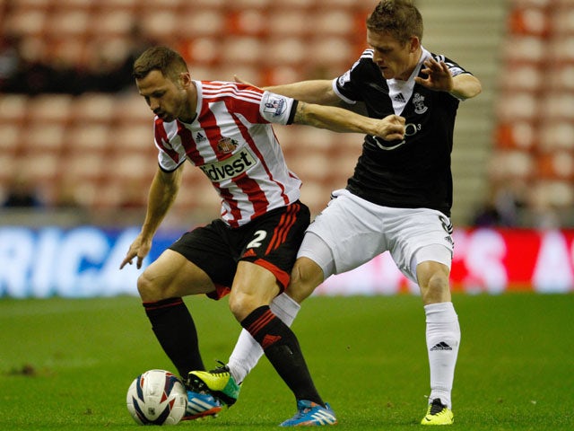 Phil Bardsley of Sunderland vies with Stephen Davis of Southampton during the Capital One Cup fourth Round match between Sunderland and Southampton at Stadium of Light on November 06, 2013