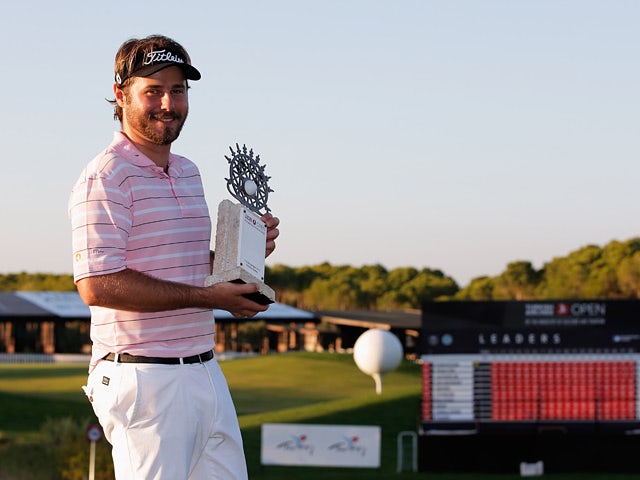 Victor Dubuisson celebrates with the trophy after winning the Turkish Airlines Open on November 10, 2013