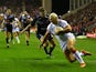 Ryan Hall of England slides over the line to score his second try during the Rugby League World Cup Quarter Final match between England and France at DW Stadium on November 16, 2013