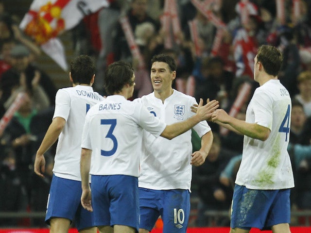 England's Gareth Barry celebrates with teammates after scoring a goal during the friendly football match between England and Sweden at the Wembley Stadium in London, on November 15, 2011
