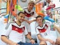 Playmakers Thomas Muller (C) and Julian Draxler (R) help unveil the Germany World Cup kit in Munich on November 12, 2013