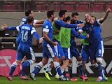 Greece's Kostas Mitroglou celebrates with teammates after scoring during the 2014 FIFA World Cup qualifying play-off first leg football match between Greece and Romania at the Karaiskaki stadium in Athens on November 15, 2013
