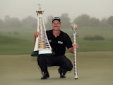 Henrik Stenson of Sweden poses with the Race To Dubai trophy and the DP World Tour Championship trophy after winning the latter on November 17, 2013