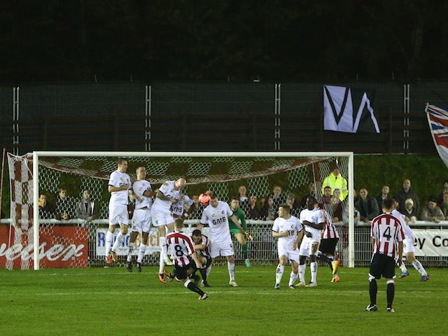 Jake Parrott of Shortwood United hits a free kick during the FA Cup First Round match between Shortwood United and Port Vale at Meadowbank Stadium on November 11, 2013