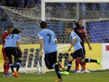 Uruguay's defender Maxi Pereira celebrates after scoring the opening goal for his team during their FIFA 2014 World Cup qualifier football match against Jordan at the International Stadium on November 13, 2013