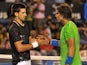 Novak Djokovic of Serbia shakes hands with Rafael Nadal of Spain at the net after the men's final match on day 14 of the 2012 Australian Open tennis tournament early on January 30, 2012