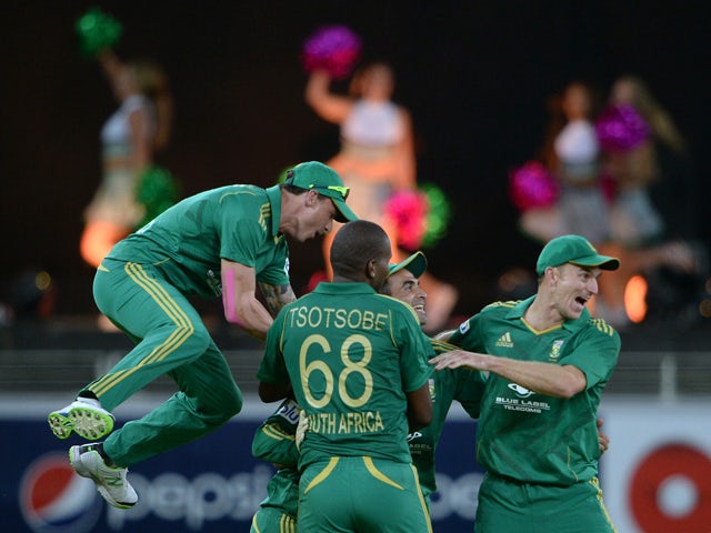 South African cricketers celebrate after taking a wicket of Pakistani batsman Sohaib Maqsood during the second and last cricket T20 International at Dubai stadium on November 15, 2013