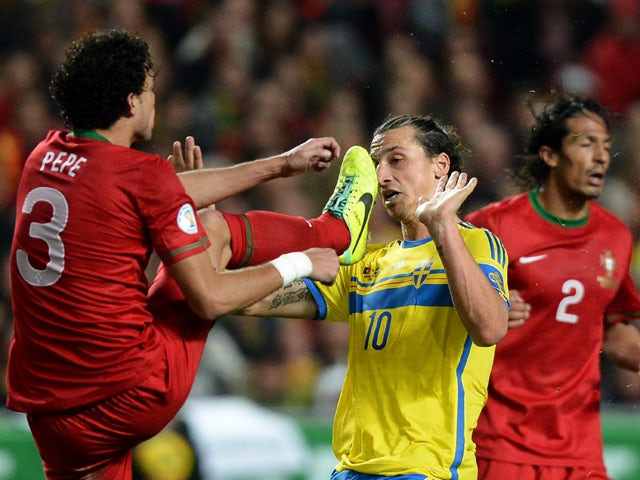 Sweden's forward Zlatan Ibrahimovic vies with Portugal's defender Pepe during the FIFA 2014 World Cup qualifier play-off first leg football match Portugal vs Sweden at the Luz stadium in Lisbon on November 15, 2013