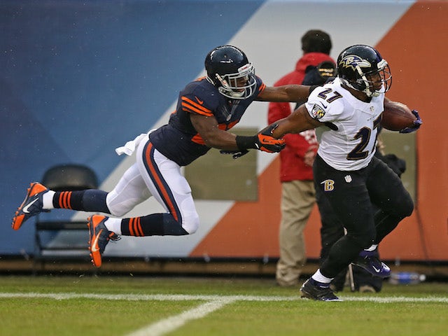 Major Wright of the Chicago Bears forces Ray Rice of the Baltimore Ravens out of bounds on a long gain at Soldier Field on November 17, 2013
