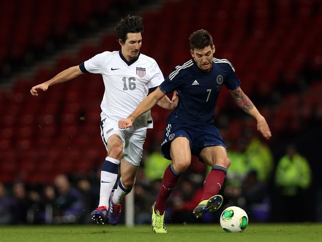 United States' Sacha Kljestan chases Scotland's Charlie Mulgrew during the international friendly football match between Scotland and the United States of America at Hampden Park in Glasgow on November 15, 2013