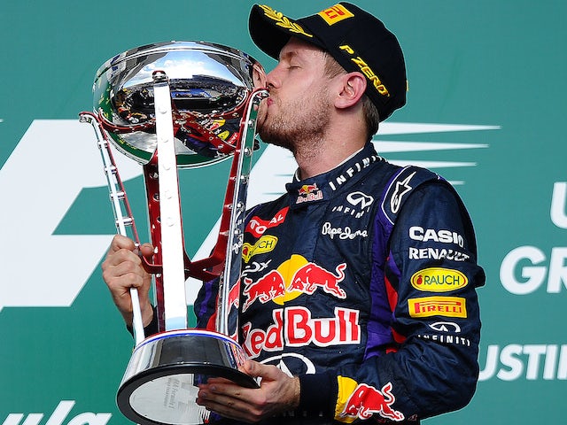 Red Bull Racing's German driver Sebastian Vettel kisses the trophy after winning the United States Formula One Grand Prix at Circuit of The Americas on November 17, 2013