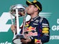 Red Bull Racing's German driver Sebastian Vettel kisses the trophy after winning the United States Formula One Grand Prix at Circuit of The Americas on November 17, 2013