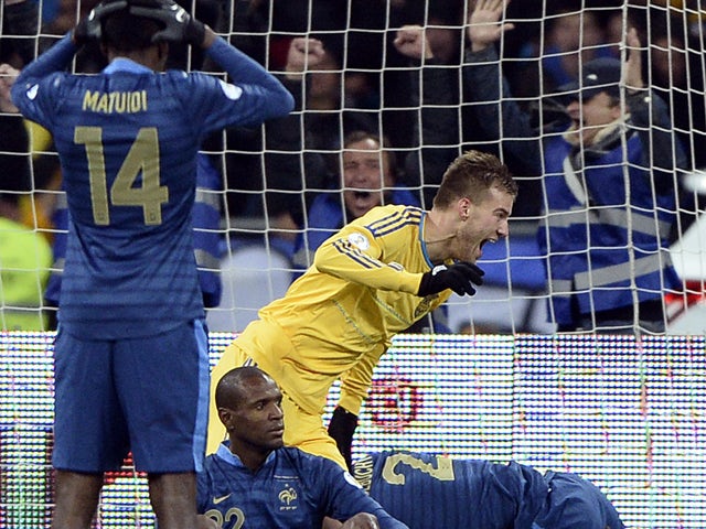 Ukraine's forward Andriy Yarmolenko celebrates next to France's defender Blaise Matuidi and defenders Eric Abidal and Laurent Koscielny after Ukraine scored a goal during the 2014 FIFA World Cup qualifying play-off first leg football match between Ukraine