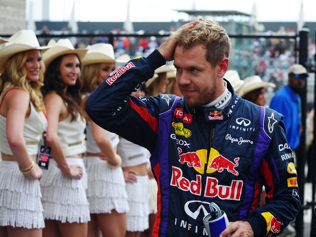 Red Bull Racing's German driver Sebastian Vettel walks off the circuit after winning the qualifying session for the United States Formula One Grand Prix at Circuit of The Americas on November 16, 2013