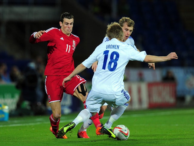 Wales striker Gareth Bale takes on the Finland defence uring the International Friendly match between Wales and Finland at Cardiff City Stadium on November 16, 2013