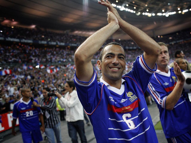 French Youri Djorkaeff waves to the crowd after the football exhibition match between France's 1998 World Cup champions and a world selection team, on July 12, 2008