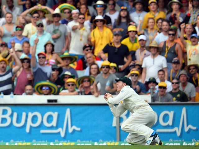 Australia's Chris Rogers takes a catch off England's batsman Stuart Broad at the boundary line to wind up England's first innings during day two of the first Ashes cricket Test match between England and Australia at the Gabba Cricket Ground in Brisbane on