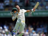 Australia's batsman David Warner jumps in air to celebrates his unbeaten century during day three of the first Ashes cricket Test match between England and Australia at the Gabba Cricket Ground in Brisbane on November 23, 2013