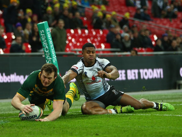 Brett Morris of Australia scores a try as Kevin Naiqama of Fiji challenges during the Rugby League World Cup Semi Final match between Australia and Fiji at Wembley Stadium on November 23, 2013