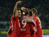 Bayern Munich's players celebrate after scoring the first goal during the German first division Bundesliga football match between Borussia Dortmund on November 23, 2013