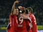 Bayern Munich's players celebrate after scoring the first goal during the German first division Bundesliga football match between Borussia Dortmund on November 23, 2013