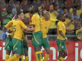 South Africa's Bernard Parker is congratulated by teammates after scoring the opening goal against Spain during an international friendly match on November 19, 2013