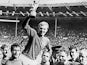 The England players lift Bobby Moore up with the World Cup trophy on July 30, 1966.