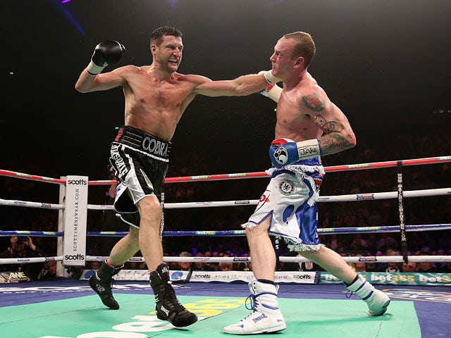 Carl Froch connects with George Groves during their IBF & WBA World Super Middleweight Title fight on November 23, 2013