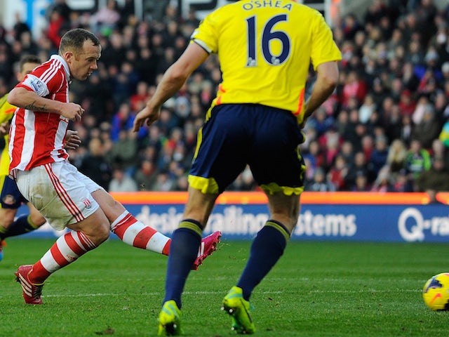 Stoke City's midfielder Charlie Adam scores the opening goal during the English Premier League football match between Stoke City and Sunderland on November 23, 2013