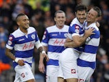 Charlie Austin of QPR celebrates with team mate Clint Hill after scoring the first goal of the game during the Sky Bet Championship match against Charlton on November 23, 2013