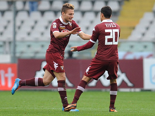 Torino's Ciro Immobile celebrates with teammate Giuseppe Vives after scoring the opening goal against Catania during their Serie A match on November 24, 2013