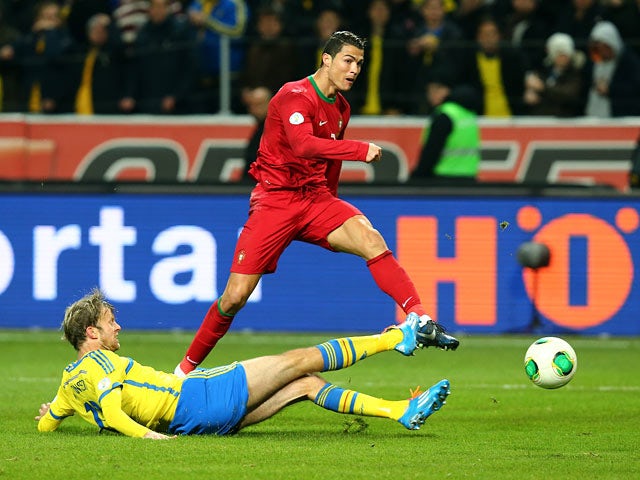Portugal's Cristiano Ronaldo scores his team's second goal against Sweden during their World Cup play-off match on November 19, 2013