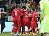 Portugal's Cristiano Ronaldo celebrates with teammates after scoring his team's third goal against Sweden during their World Cup play-off match on November 19, 2013