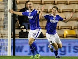 Oldham's Danny Phillispkirk celebrates with teammate David Mellor after scoring the opening goal against Wolves during their FA Cup first round match on November 19, 2013