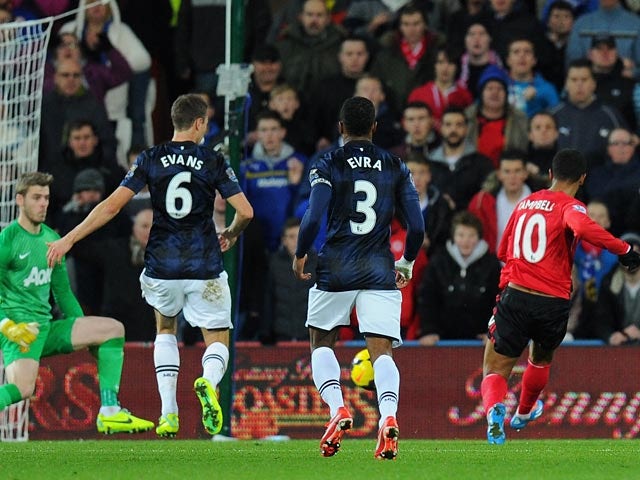 Cardiff's Fraizer Campbell scores his team's opening goal and equaliser against Manchester United during their Premier League match on November 24, 2013