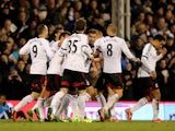 Scott Parker of Fulham is congratulated by teammates after scoring a goal to level the scores at 1-1 during the Barclays Premier League match between Fulham and Swansea City at Craven Cottage on November 23, 2013