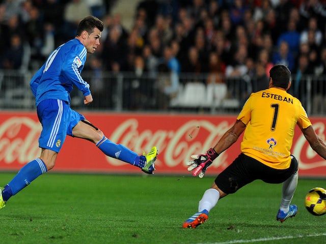 Real Madrid's Welsh forward Gareth Bale scores during the Spanish league football match UD Almeria vs Real Madrid at the Mediterraneos stadium in Almeria on November 23, 2013