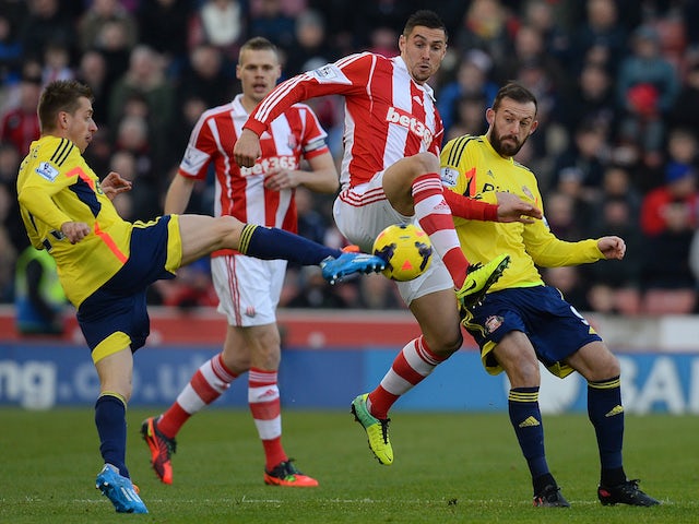 Stoke City's defender Geoff Cameron vies with Sunderland forward Steven Fletcher and midfielder Emanuele Giaccherini during a game on November 23, 2013