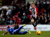 George Saville of Brentford breaks away from the challenge of Byron Moore of Crewe during the Sky Bet League One match between Brentford and Crewe Alexandra at Griffin Park on November 16, 2013
