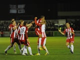 Glenn Walker of Brackley Town celebrates with Curtis McDonald (3) and team-mates after scoring during the FA Cup First Round Replay match against Gillingham on November 18, 2013
